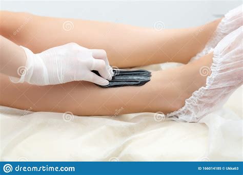 Beautician Hair Removal Procedure on the Client`s Feet in Beauty Parlor ...