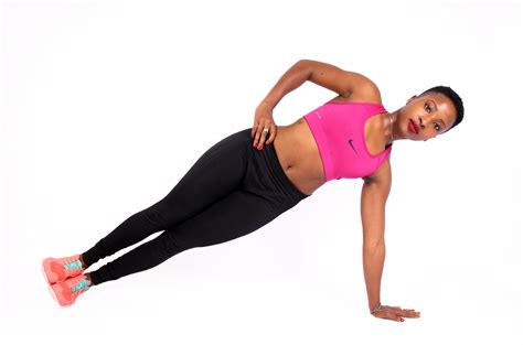 Fit woman doing side plank with hand on hips