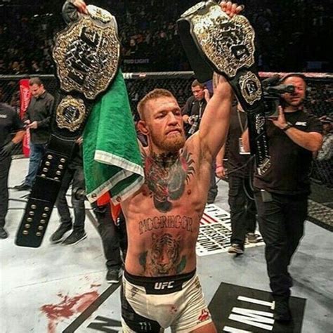 Conor McGregor with both, the lightweight and featherweight titles ...