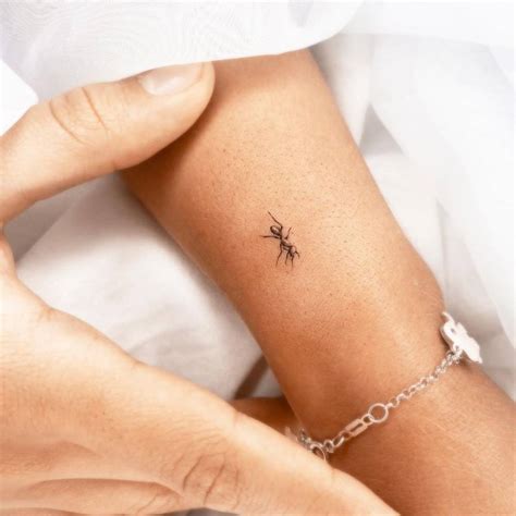 Micro-realistic ant tattoo on the wrist.