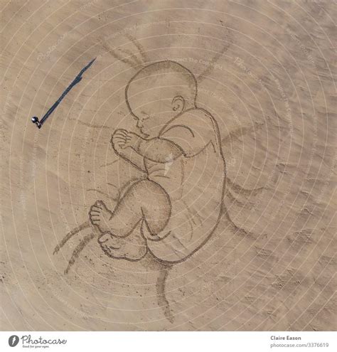 Giant sand art drawing of a sleeping baby with person for scale - a Royalty Free Stock Photo ...