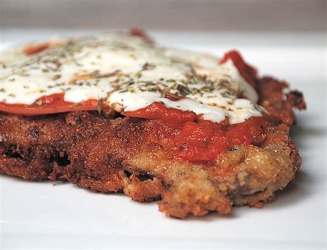 Try this Milanesa Napolitana recipe, an Argentinian favorite. Breaded fried steak is topped with ...