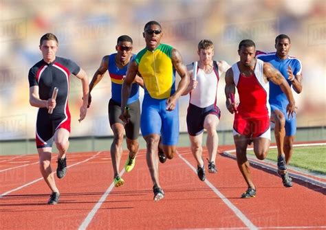 Six athletes running on race track - Stock Photo - Dissolve