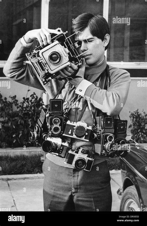 Photographer with 35mm medium & large format format film cameras 1970 Stock Photo - Alamy