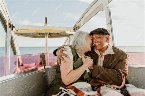 Premium Photo | Cheerful senior couple enjoying a ferris wheel by the ...