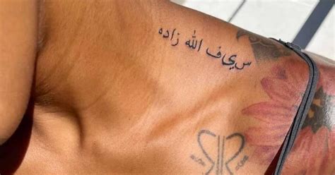 Arabic lettering tattoo located on Asiah Azante's top