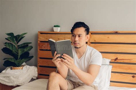 Man is Reading Book on His Bed in Late Afternoon. Stock Photo - Image of literacy, carefree ...