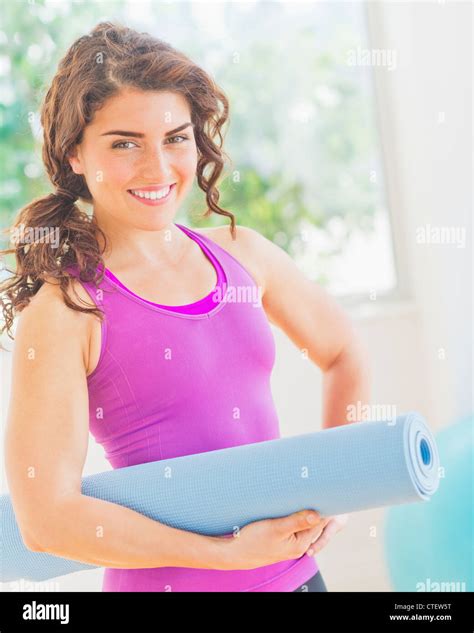 USA, New Jersey, Jersey City, Woman holding rolled up yoga mat Stock Photo - Alamy