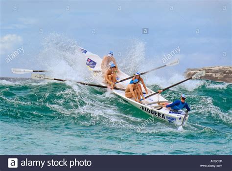 surf life saving rowing boat on wave at a surf carnival at Coogee in ...