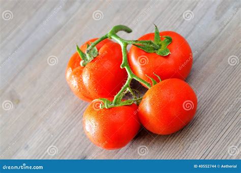 Fresh Tomatoes with Water Droplets Closeup, on the Wooden Kitchen Table ...