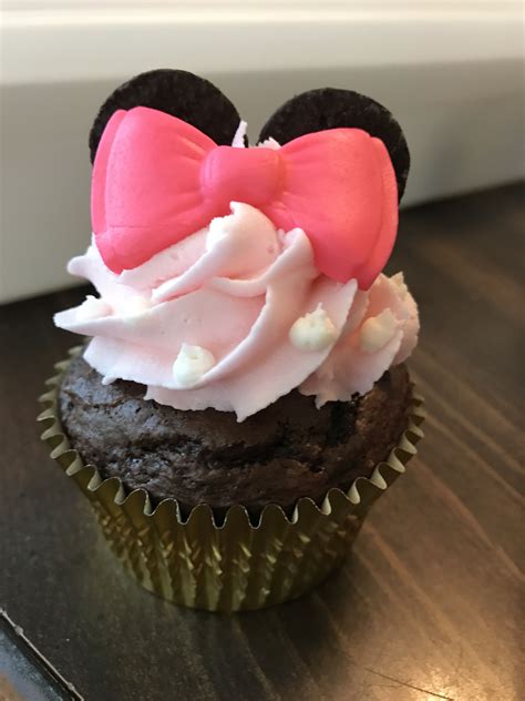 a minnie mouse cupcake with pink frosting on top