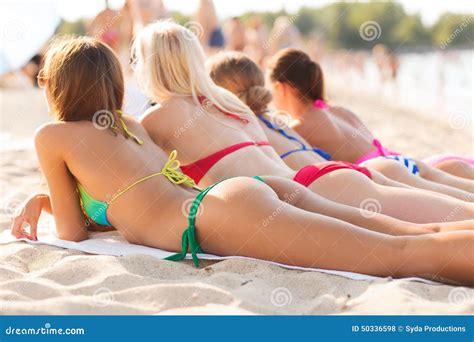 Close Up of Young Women Lying on Beach Stock Photo - Image of cellulite, relaxation: 50336598