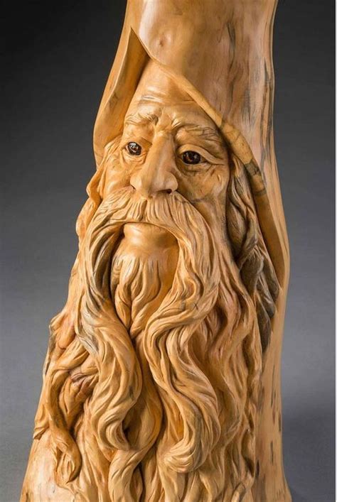 a wooden statue of an old man with long hair and beard