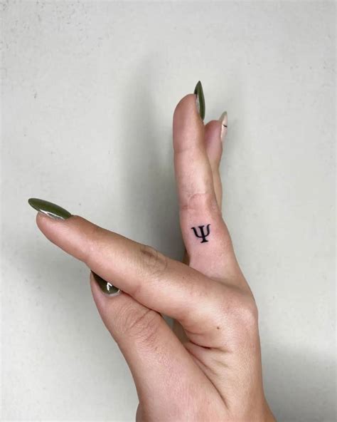 Minimalist psi letter tattoo on the finger.