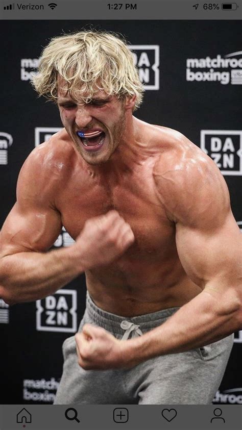 a man with blonde hair and no shirt on is flexing his muscles in front of a microphone