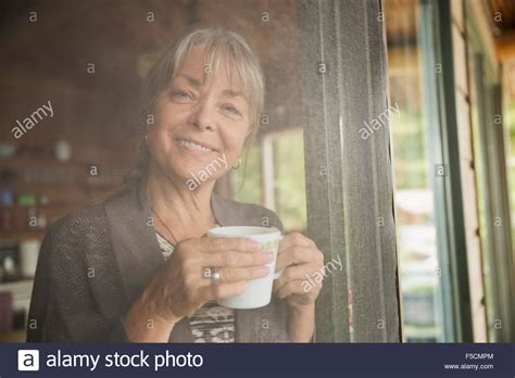 Smiling woman standing door hi-res stock photography and images - Alamy