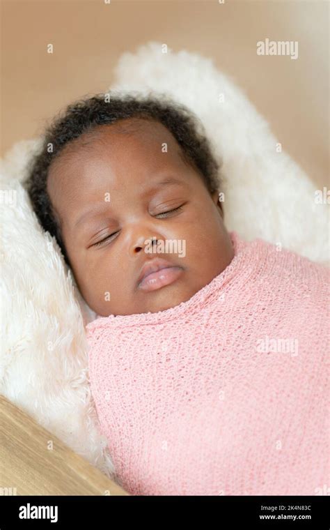 Black african baby girl taking a nap wrapped up studio close up Stock Photo - Alamy