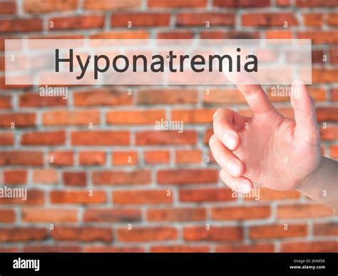 Hyponatremia - Hand pressing a button on blurred background concept . Business, technology ...