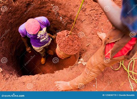 Young Boys Manually Digging Well with Bucket Full of Soil in African ...