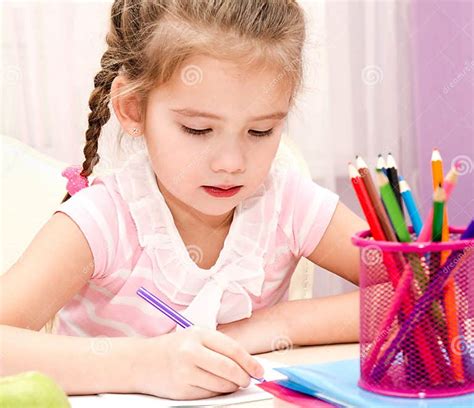 Cute Little Girl is Writing at the Desk Stock Image - Image of ...