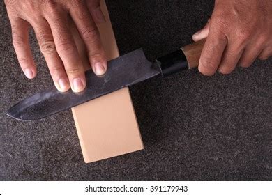 Man Sharpening Knife On Dark Background Stock Photo 2068524380 | Shutterstock