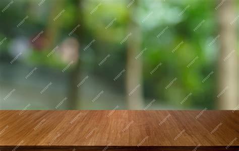 Premium Photo | Empty wood table top and blur of out door garden background Empty wooden table ...