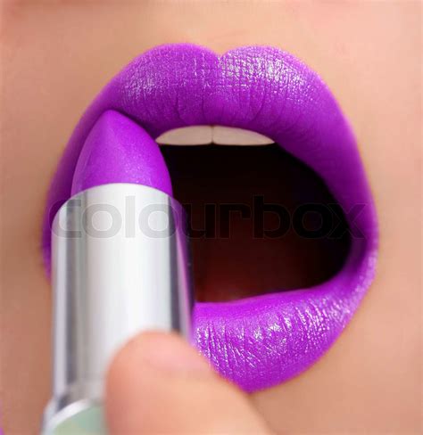 Making Herself Glamorous With Mauve Lipstick | Stock image | Colourbox