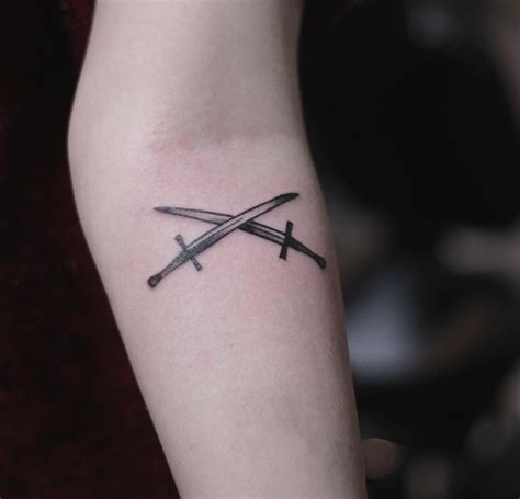 Two swords tattoo done by kristian kriistian - Tattoogrid.net