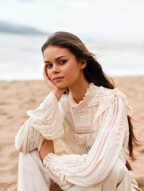 Premium Photo | Stylish lady posing on sunny beach embracing the ...