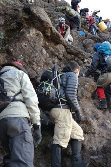 Father and son climb Mount Kilimanjaro for challenge and charity: Faces ...