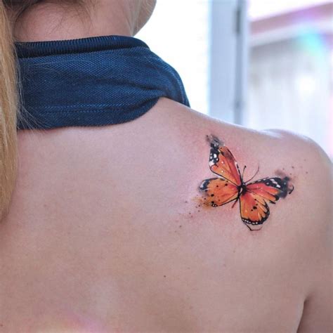 Watercolor butterfly tattoo on the shoulder.