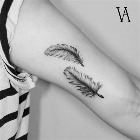 Two feathers on the left inner arm.