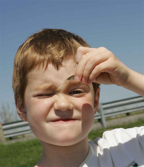 File:Close up of face of young boy holds a small fish.jpg