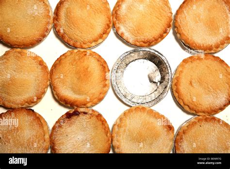 MInce pies surrounding an empty foil container for an already eaten ...