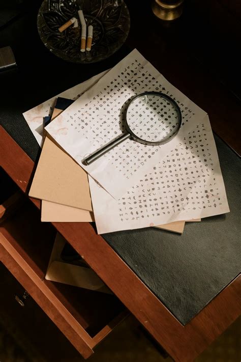 Photo of Cryptic Character Codes and Magnifying Glass on Table Top · Free Stock Photo