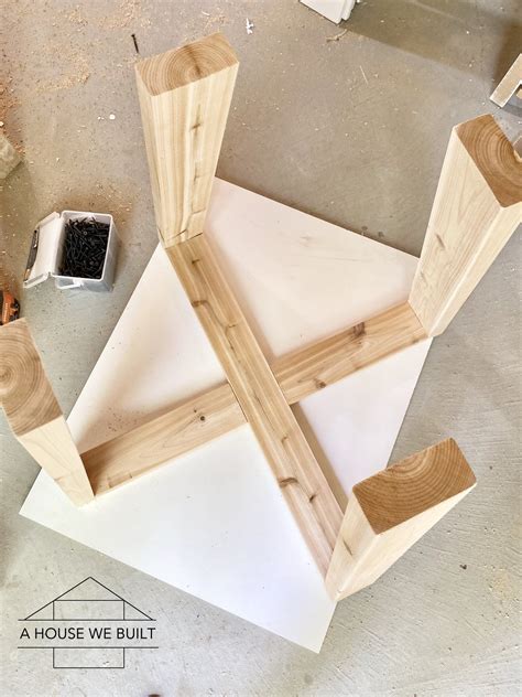 some wood pieces sitting on top of a white floor next to a small potted plant