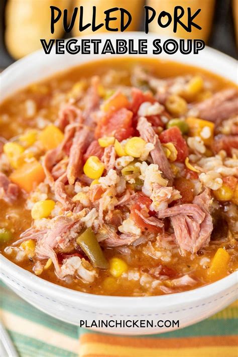 a bowl of pulled pork vegetable soup with corn and carrots on the side, in a white bowl