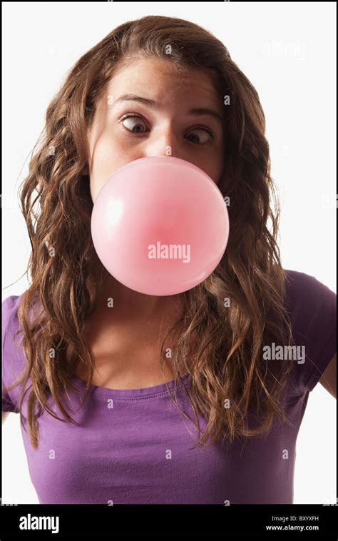 Young woman blowing bubble gum Stock Photo - Alamy