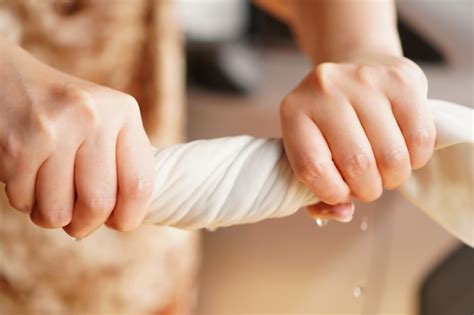 Premium Photo | Two hands wring wet cloth after washing by twist and ...