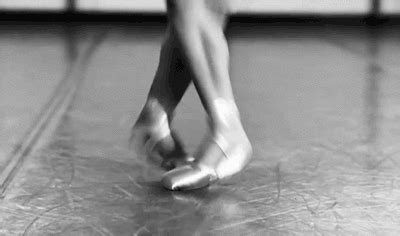 black and white photograph of woman's legs in ballet shoes