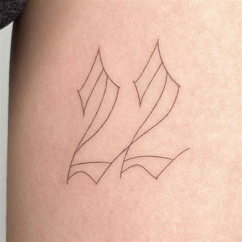 Tattoo of the number "22" located on the inner arm.