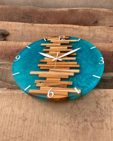 a clock made out of wood sticks on top of a wooden table