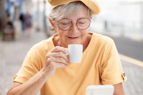 Premium Photo | Smiling attractive elderly woman in yellow enjoying ...