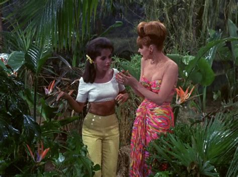 two women standing next to each other in the jungle