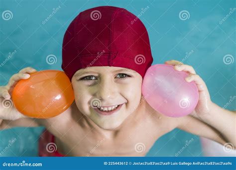 Boy with Swimming Cap and Goggles Playing with Water Balloons Stock Photo - Image of holiday ...