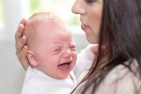 Mother and crying baby stock photo. Image of small, motherhood - 124480942