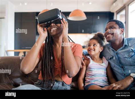 Family playing video games with VR glasses Stock Photo - Alamy