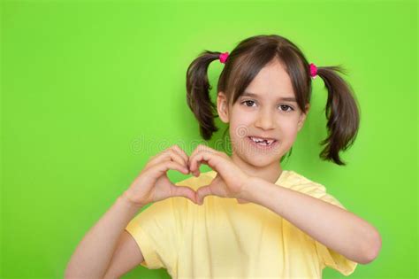 Portrait of Happy Cute Little Toddler Girl Showing Heart Shape with Hands on Green Stock Image ...