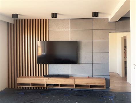 A wood slat wall and concrete in the living room | Wood slat wall, Slat ...