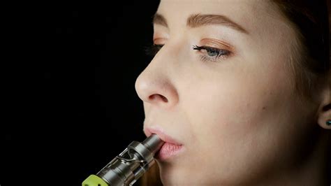 Young Beautiful Woman Smoking Electronic Cigarette On Black Background ...